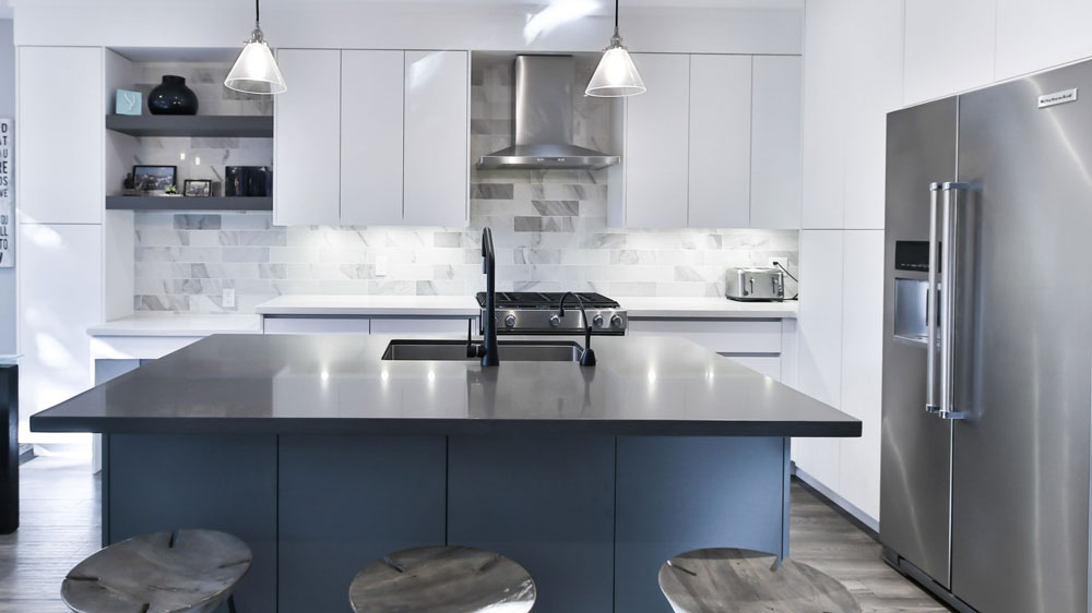 A sleek, modern kitchen with a large KitchenAid refrigerator