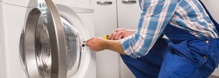 Repair technician repairing a clothes dryer