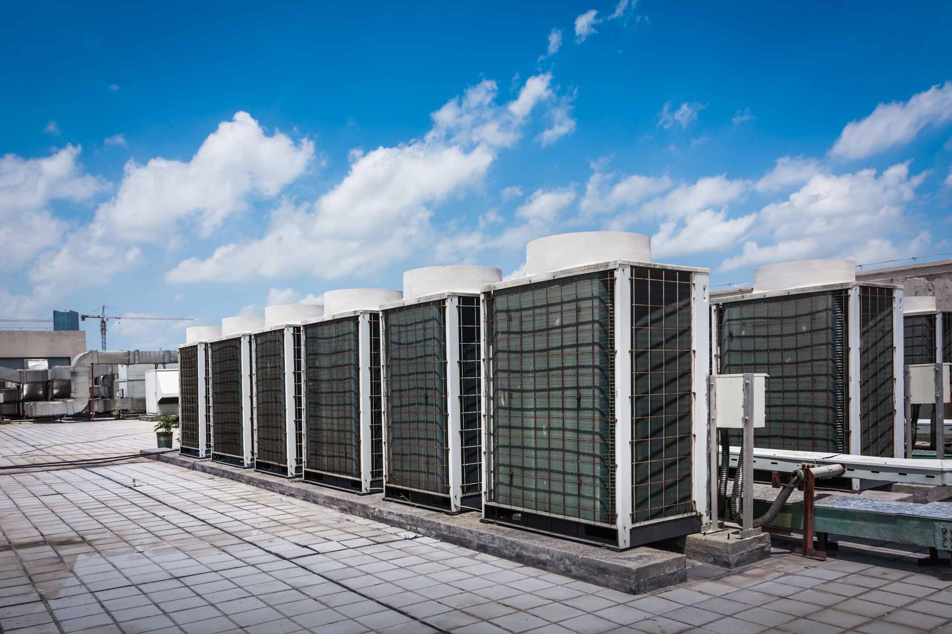 Commercial AC units on a roof under a blue sky