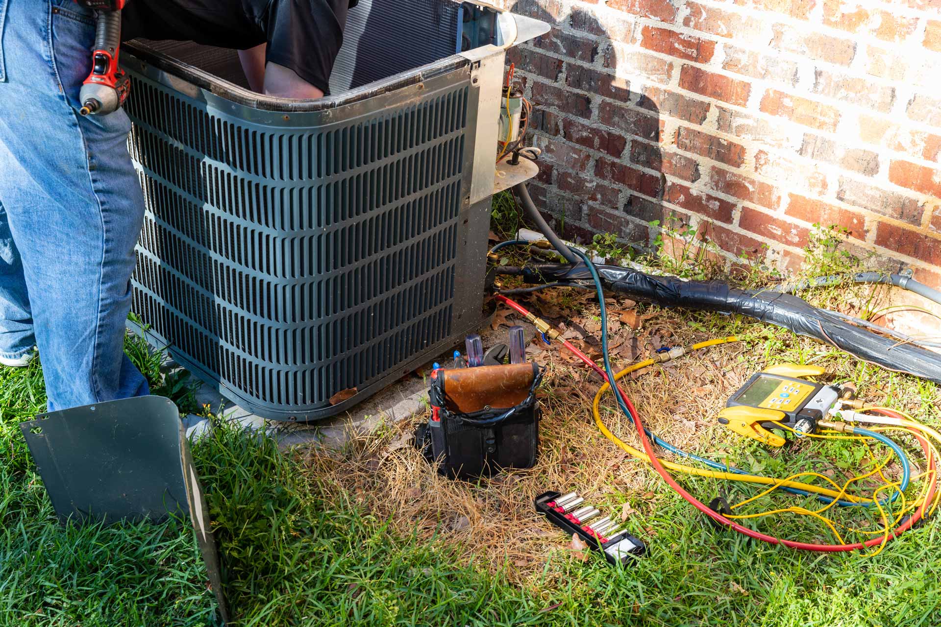 HVAC technician repairing an air conditioning unit